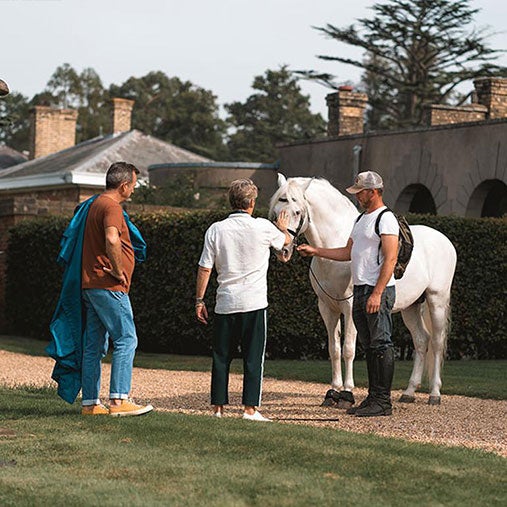 People petting horse